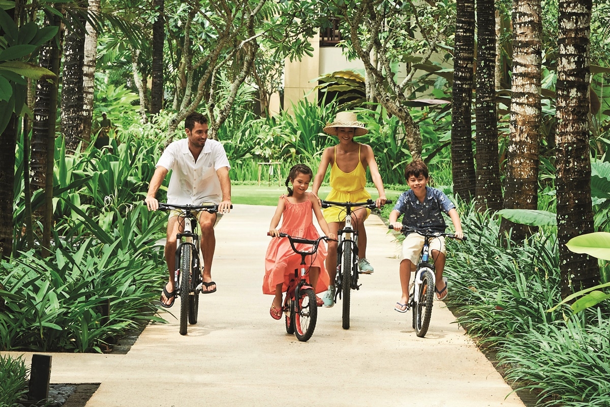 Family stays at Conrad Bali can enjoy bike riding inside the hotel.