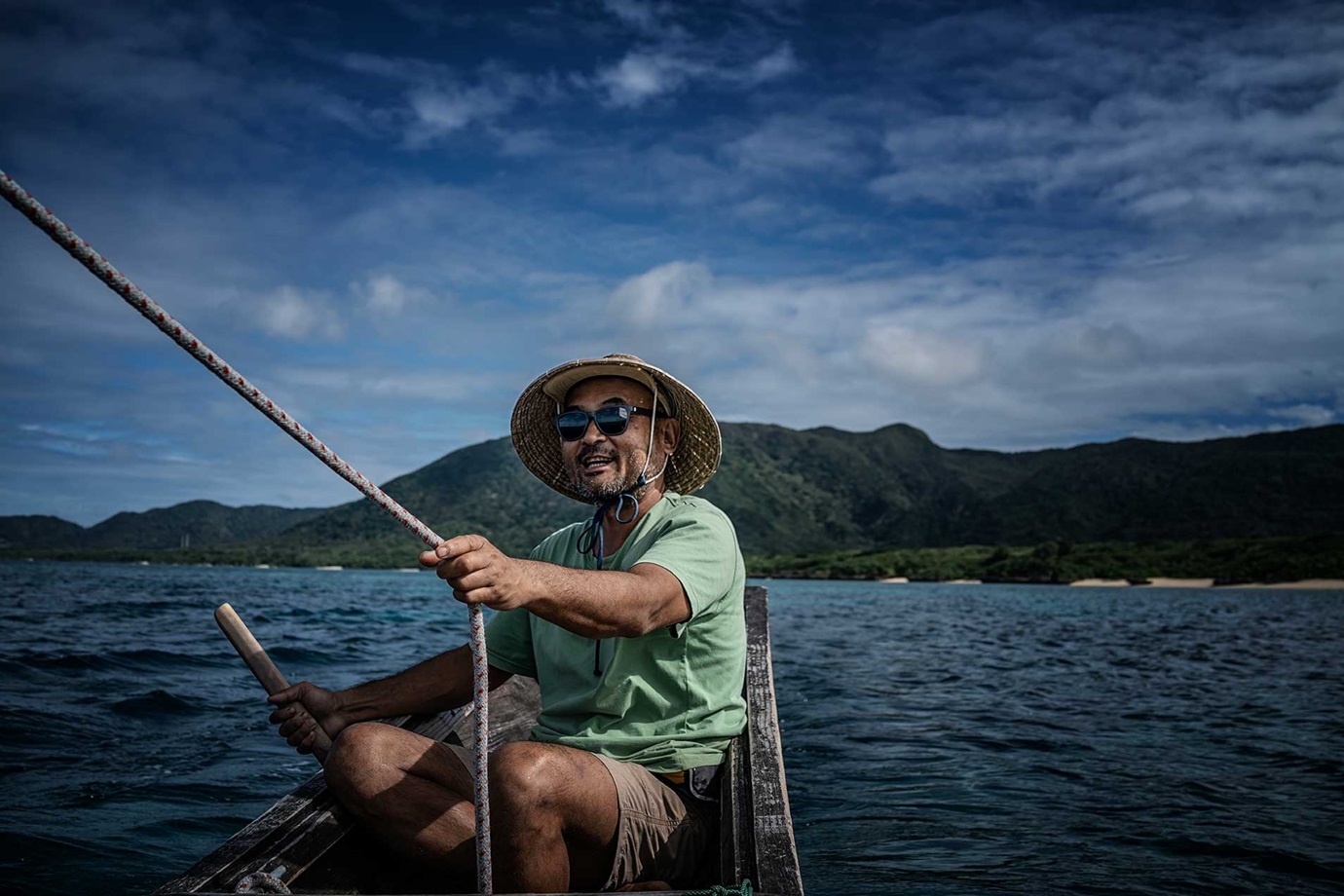 Yoshida captaining one of his boats off Ishigaki.