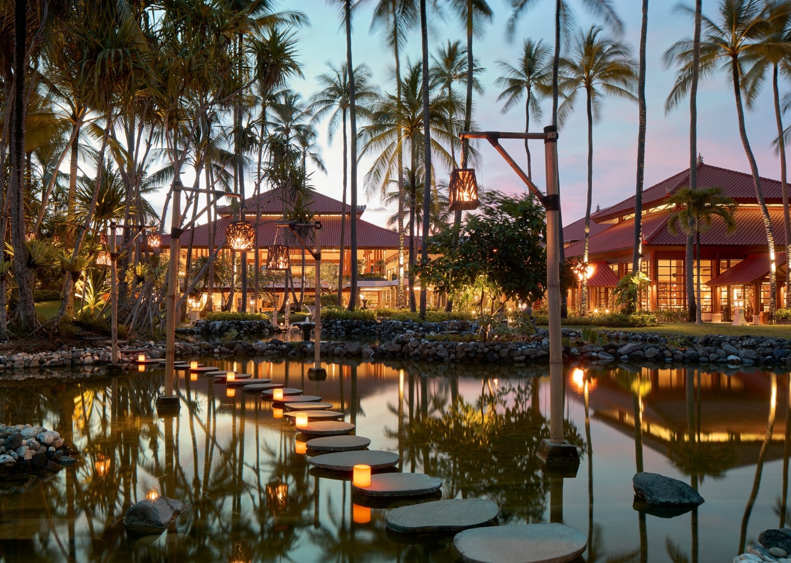 Lush tropical gardens at Paradisus by Meliá Bali feature landscaped pathways, vibrant greenery, and a serene resort atmosphere.