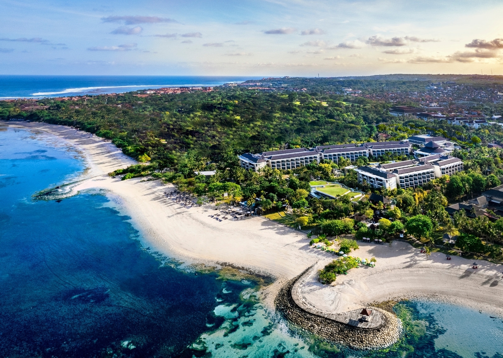 Aerial view of Sofitel Bali Nusa Dua Beach Resort with pools, gardens, and beachfront surroundings.