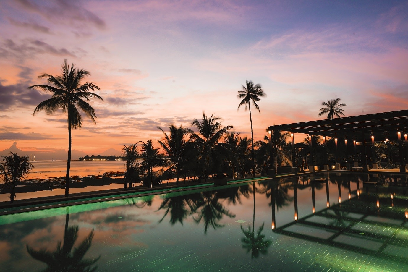 A sunset view of the main pool at The Sira, a beach resort on the Indonesian island of Lombok.