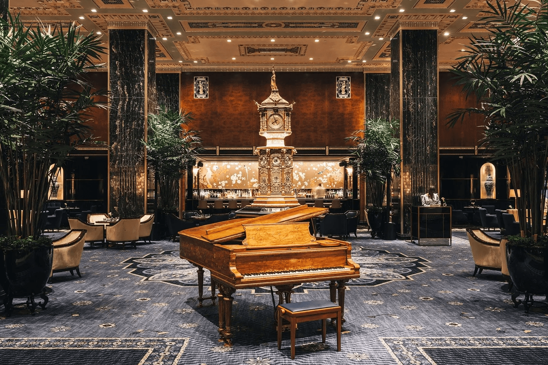 The Waldorf Astoria’s central lobby, with Cole Porter’s piano, the hotel’s iconic clock, and the Peacock Alley Bar.