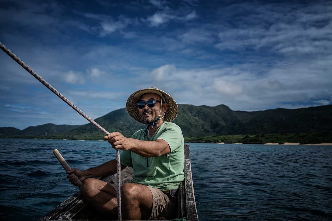 Yoshida captaining one of his boats off Ishigaki.