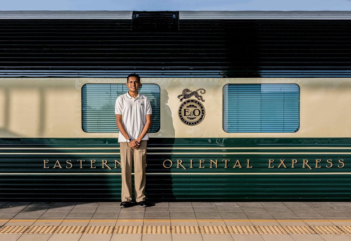 An attendant next to the Eastern & Oriental Express at the railway station in Butterworth.