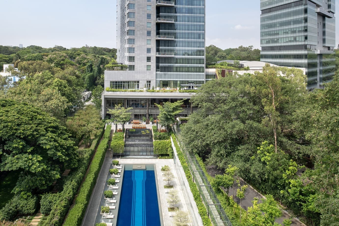 A view of the facade and outdoor pool of Four Seasons Hotel Bengaluru at Embassy One.
