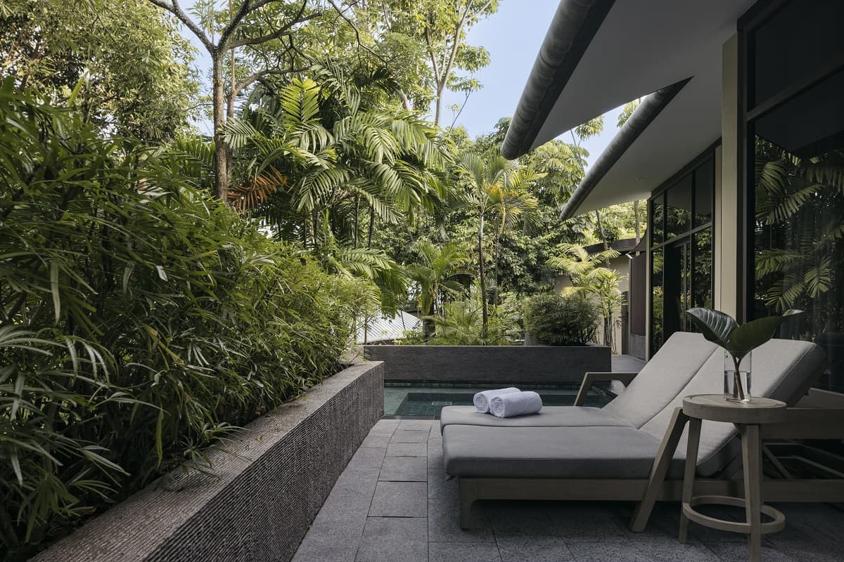 On the pool deck of a garden villa at Capella Singapore.